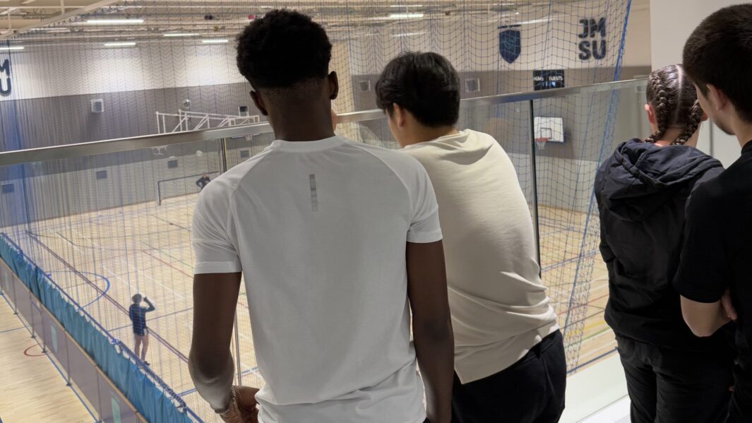 Students looking out over a sports hall