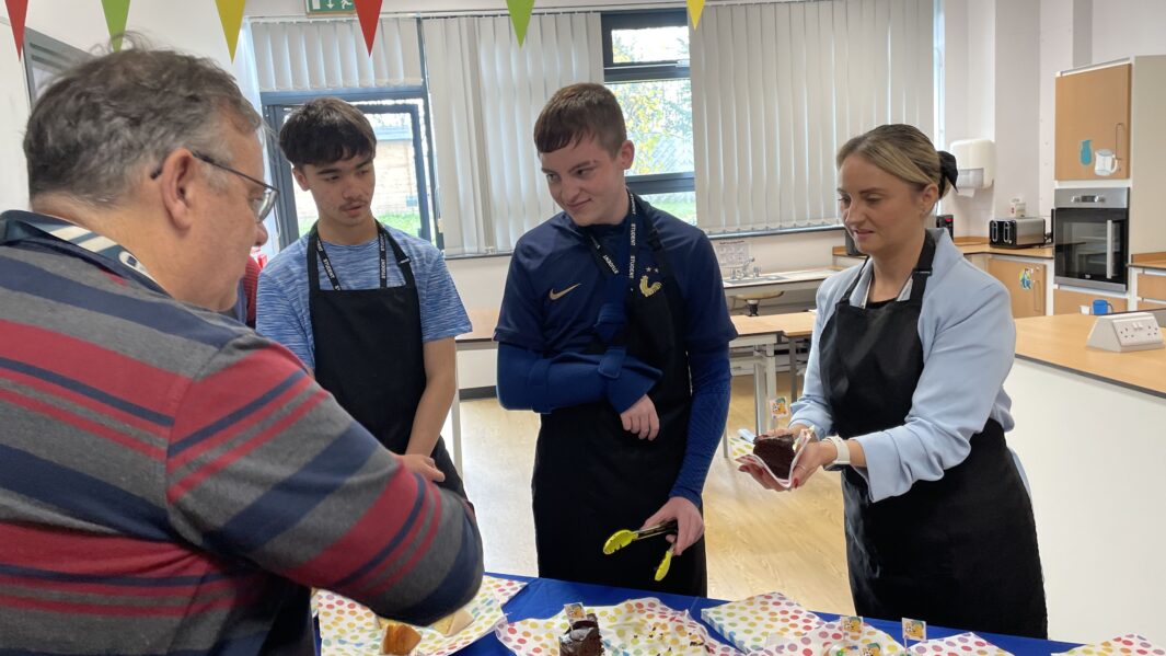students and staff at the bake sale in foundation learning