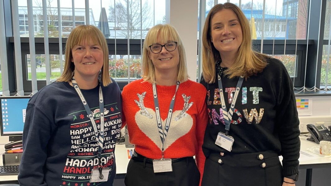 3 female staff members wearing xmas jumpers
