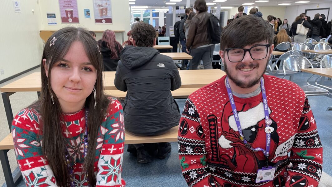 male and female students wearing xmas jumpers