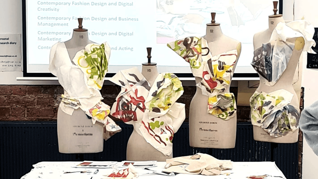 Four mannequins with unique structured garments in fashion and textile design workroom.