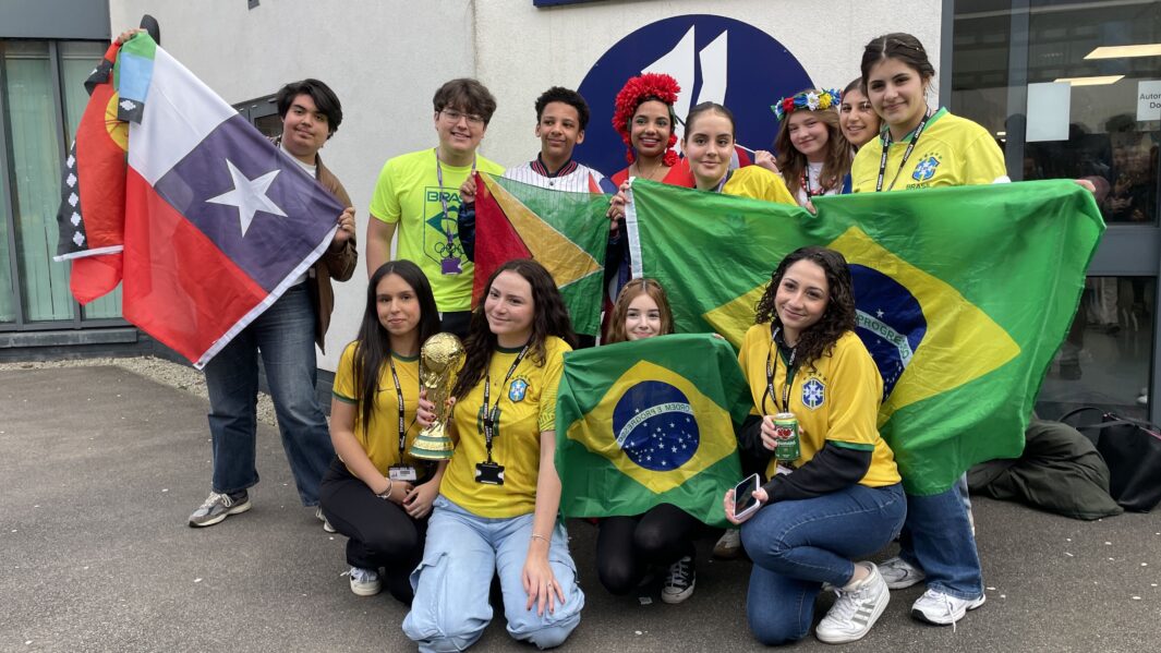Carmel College's Latin society pose as a group wearing Brazil football shirts and hold Brazilian flag.
