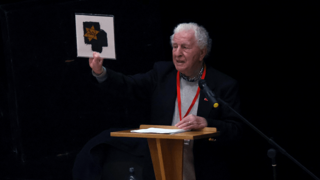 Harry Kessler stands at podium showcasing his relative's Jewish star.