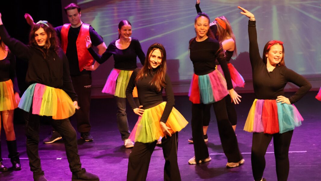 Christmas Pantomime ensemble dance in rainbow tutus.