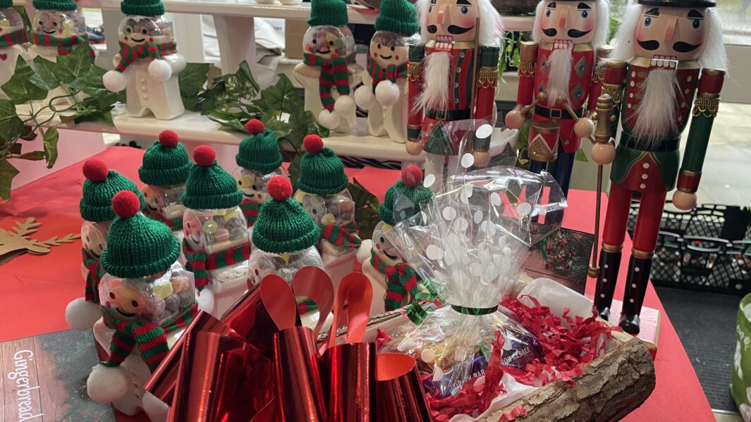Selection of handmade Christmas nutcracker and snowmen ornaments at Carmel College Christmas Market 2024.