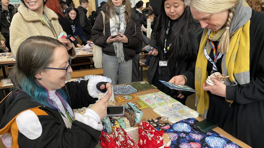 Carmel students and staff make purchase from sweet stall at Carmel Christmas Market 2024.