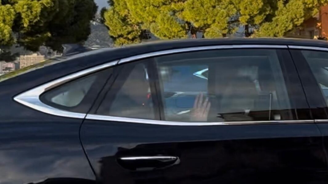 A photo of a car with the French prince in waving