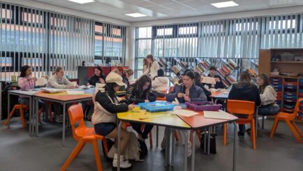 Students working at desks in an art classroom