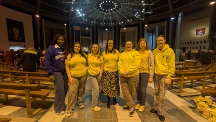 A teacher and group of students inside Liverpool Metropolitan Cathedral