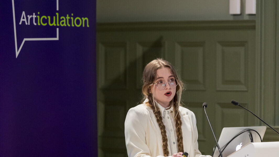 Female stood giving speech at altar