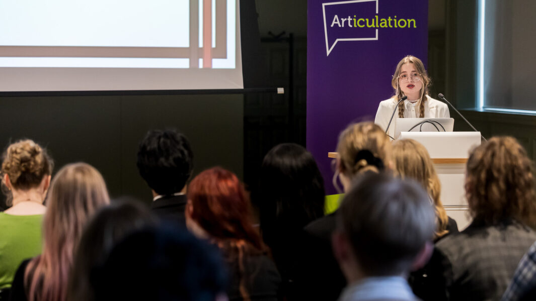 Female stood at altar giving speech in front of people