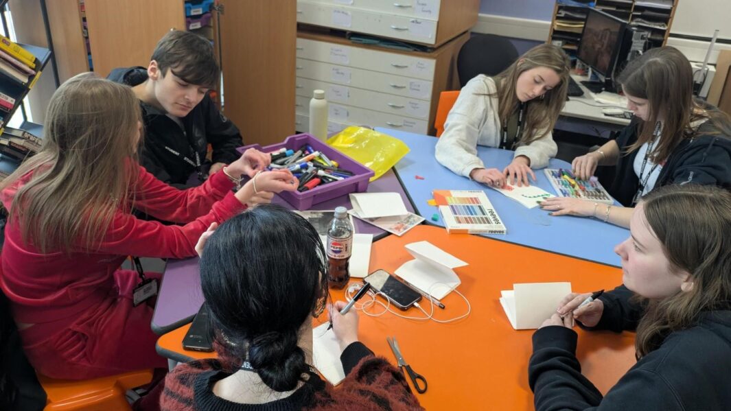 a group of students working together in an art workshop