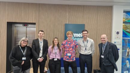 Dr Talk Crawford stood with Maths staff