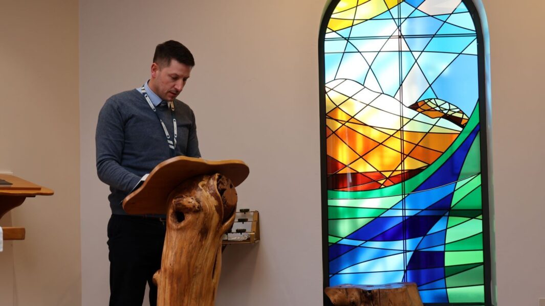 A service in our chaplaincy. male member of staff giving a reading