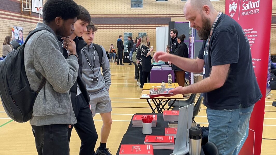 students talking to employers and universities at the careers fair