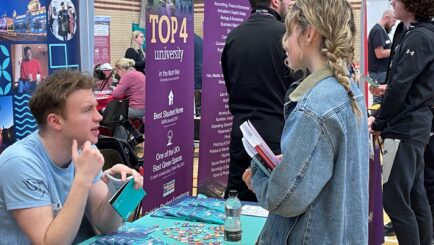 students talking to employers and universities at the careers fair