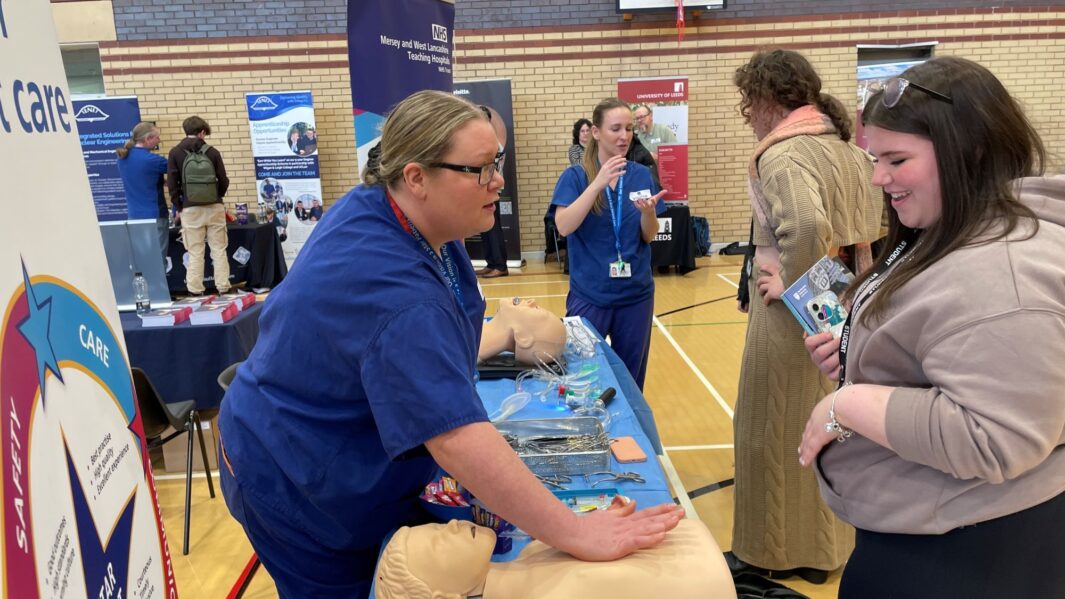 students talking to the NHS rep at the careers fair