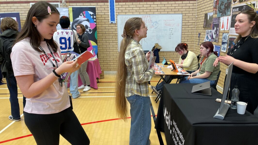 students talking to employers and universities at the careers fair