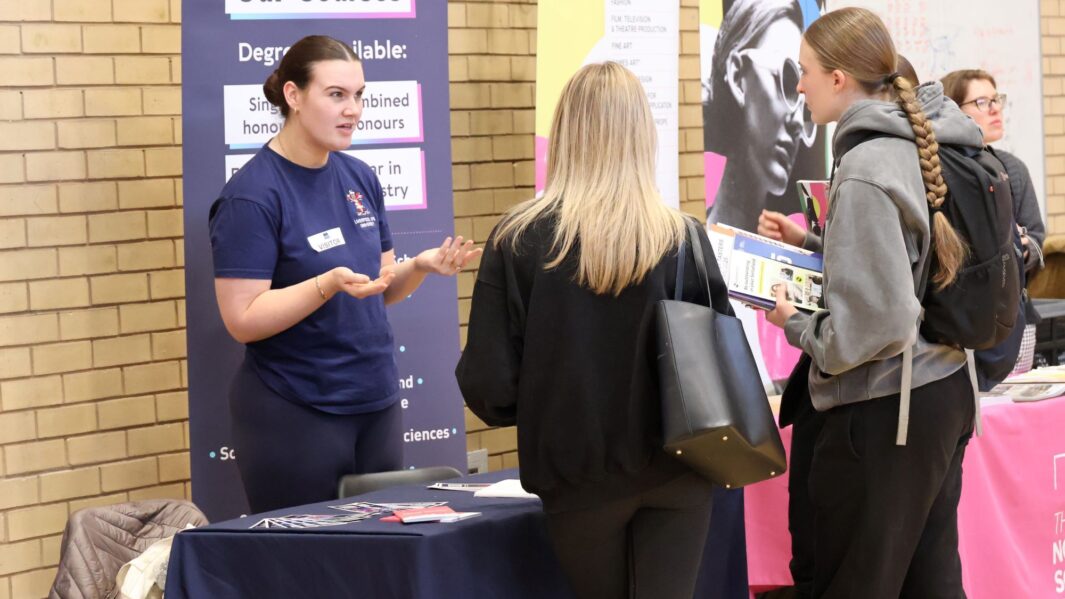 students talking to employers and universities at the careers fair