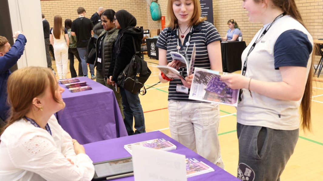 students talking to employers and universities at the careers fair