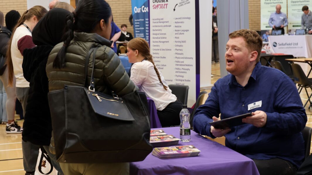 students talking to employers and universities at the careers fair