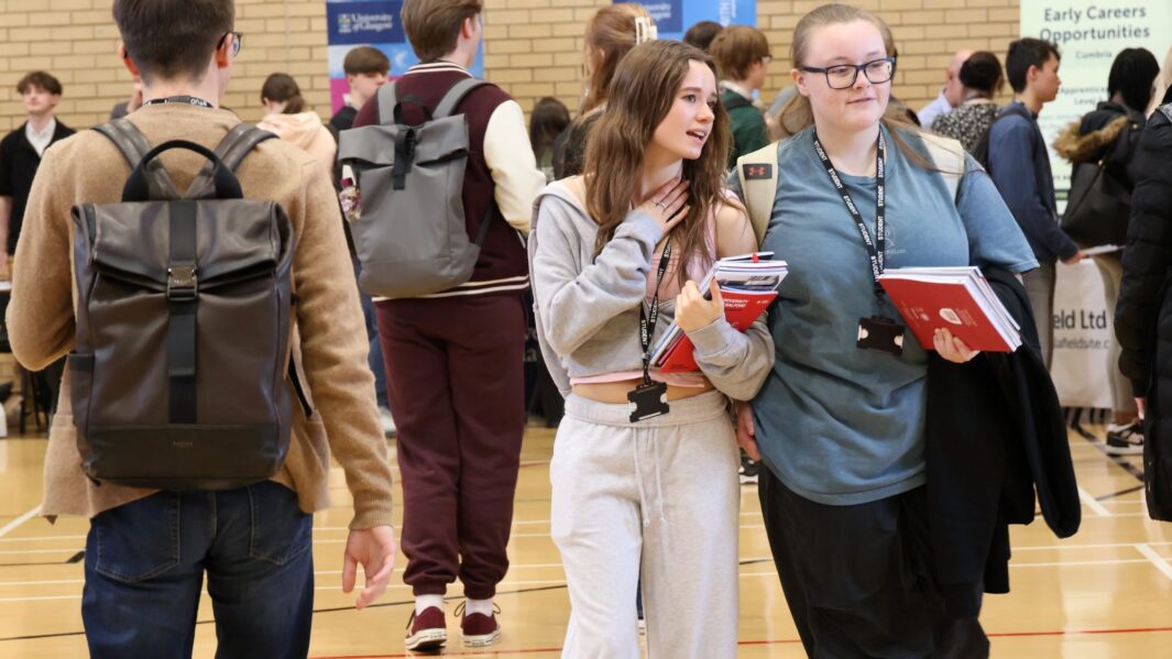 students talking to employers and universities at the careers fair