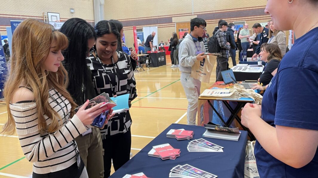 students talking to employers and universities at the careers fair