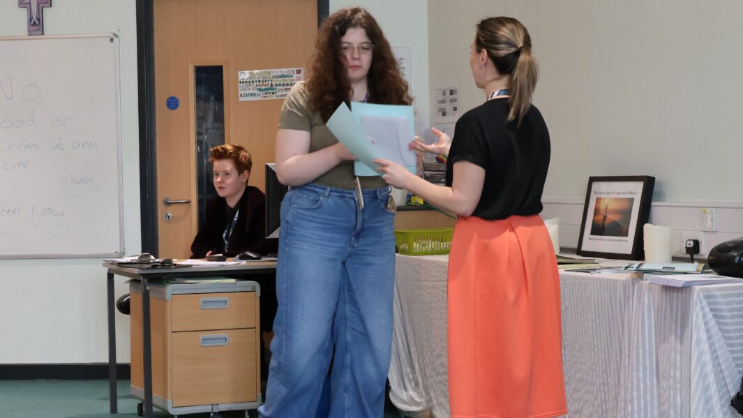 student hand certificate from teacher