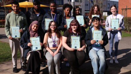 two rows of students holding certificates