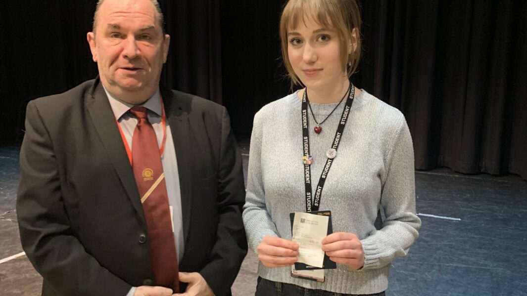 Male speaker stood to left and female student on right