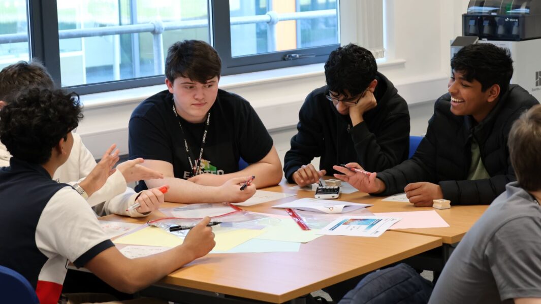 A group of maths students at a desk