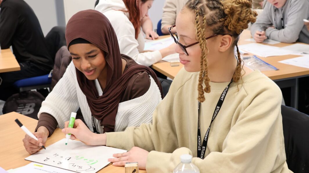 A group of maths students at a desk