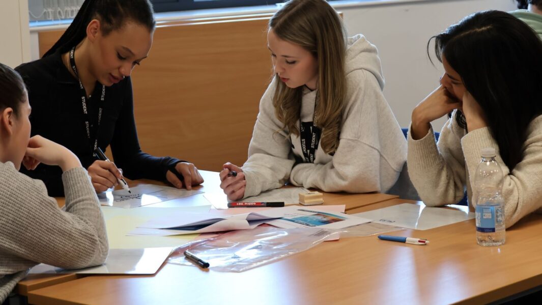 A group of maths students at a desk
