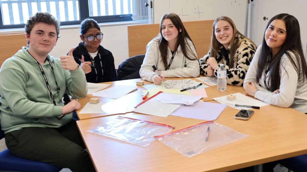 A group of maths students at a desk