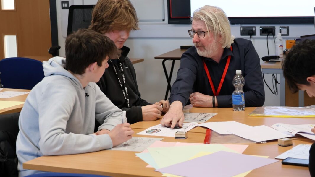 Martin Bamber sat with 2 maths students at a table