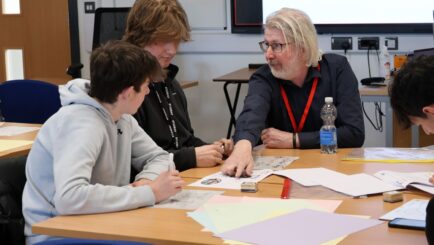 Martin Bamber sat with 2 maths students at a table