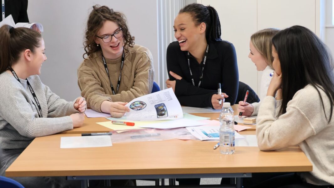A group of maths students at a desk
