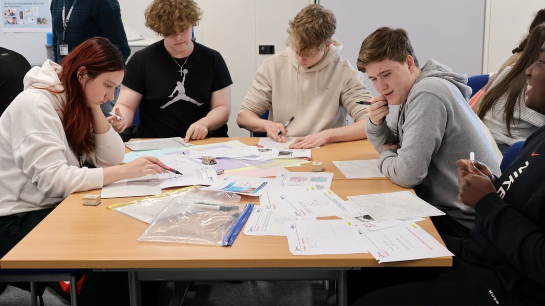 A group of maths students at a desk