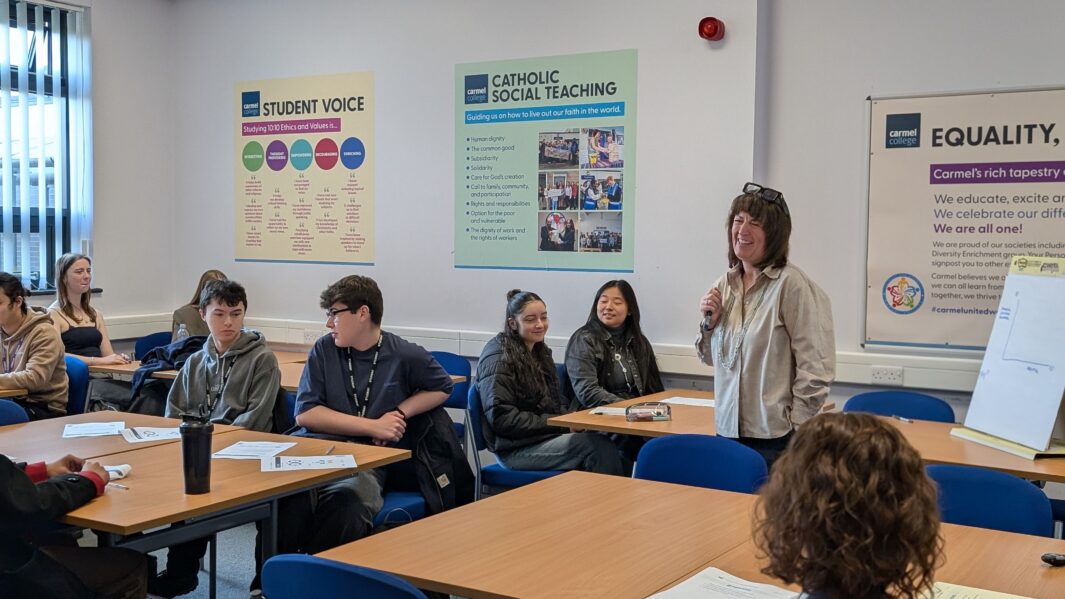 Lady speaker talking to classroom full of male and female students