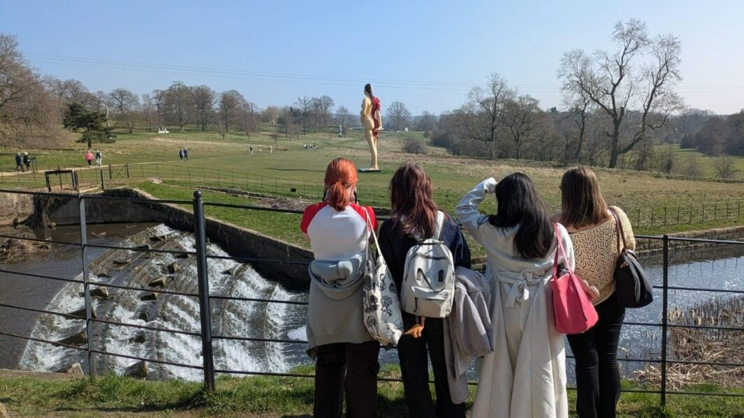 4 females looking out over a field
