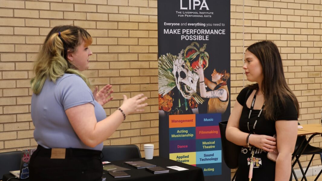 students talking to employers and universities at the careers fair