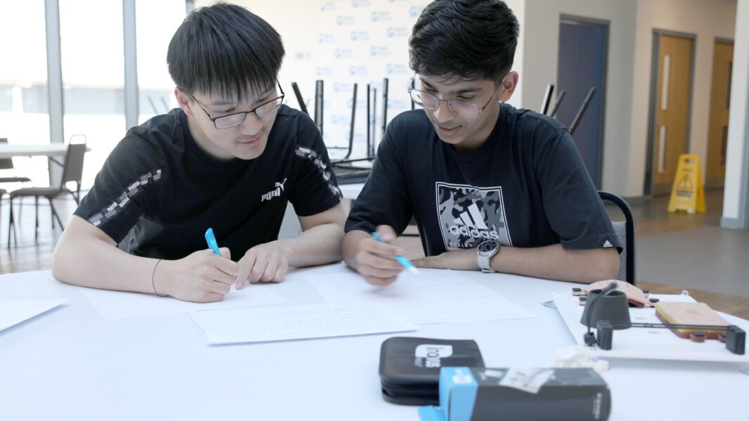 Two students sat at table working