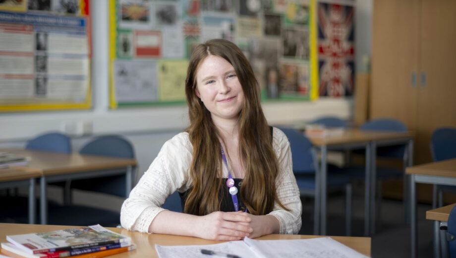 Student sat at desk with pen and paper