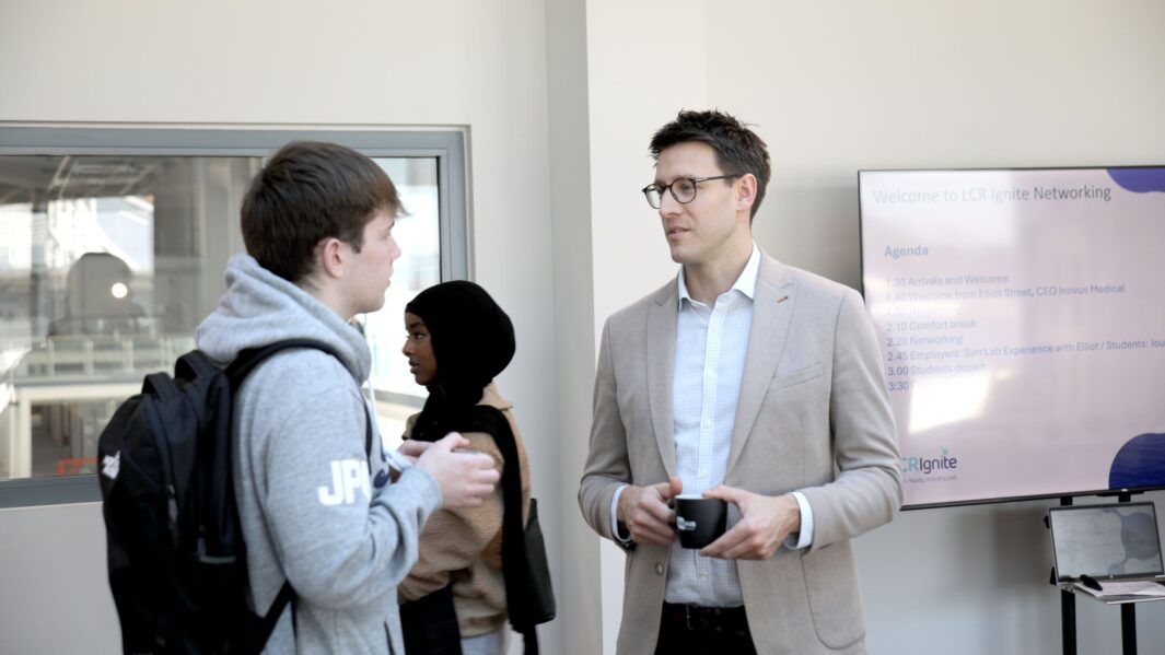 male student talking to mentor