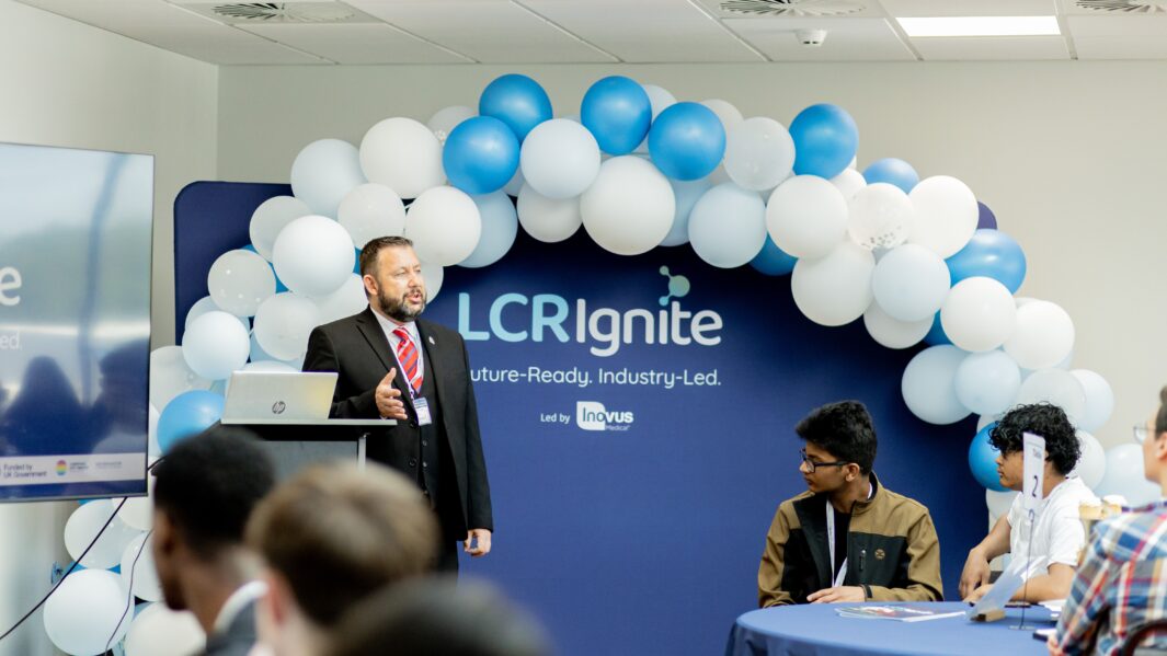Male Counsellor stood talking to room full of students