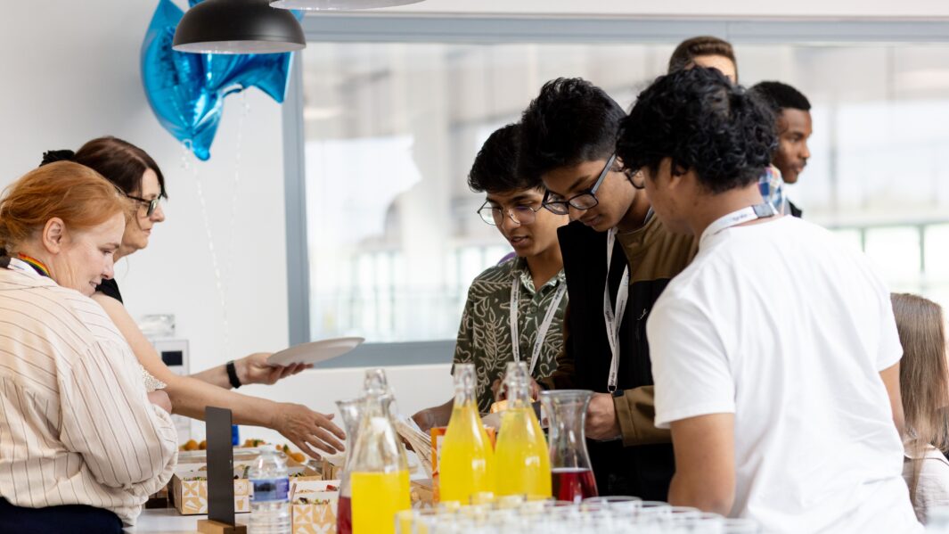 Students in a line collecting buffet food
