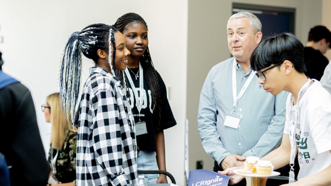 Students talking to male mentor