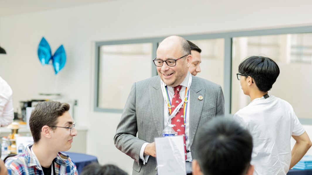 Students networking with male mentor