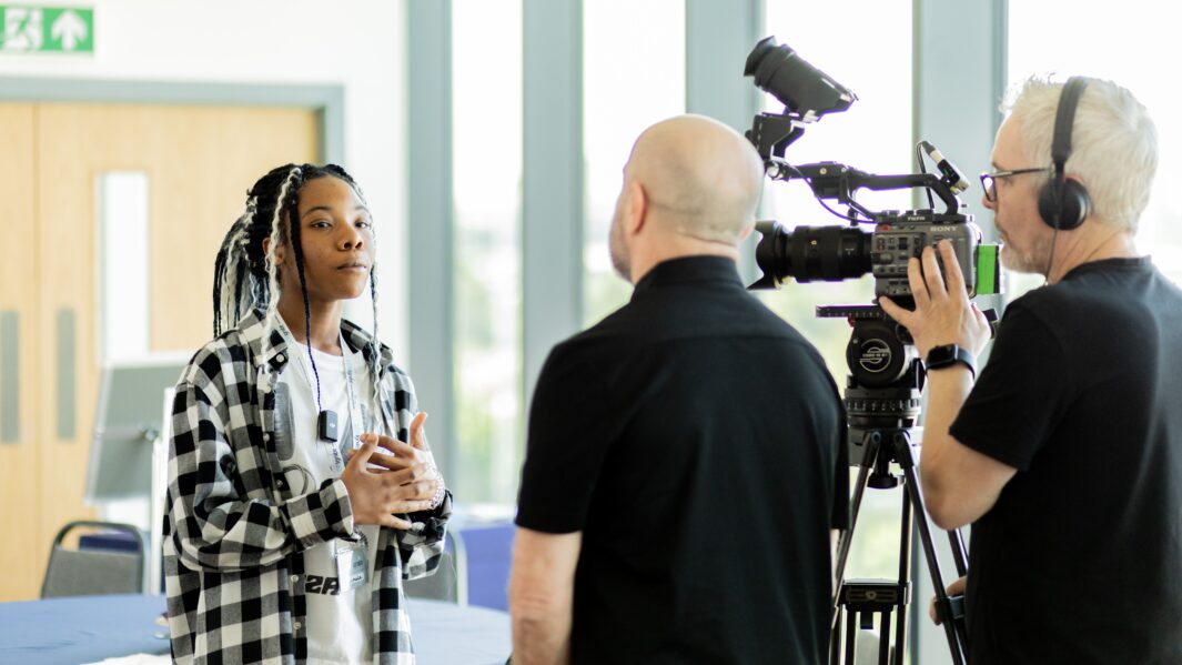Female students talking to a camera crew