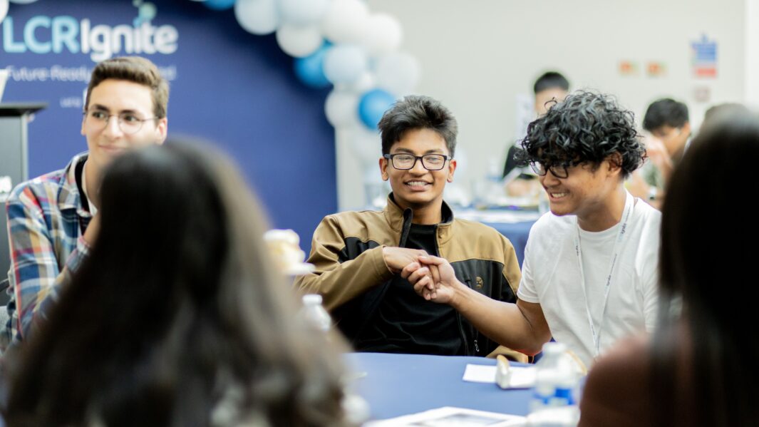 two male students shaking hands